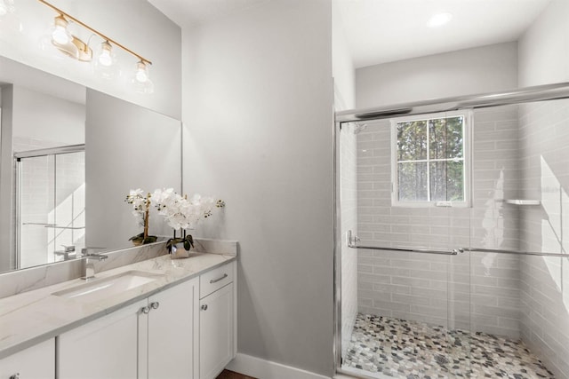 bathroom featuring vanity and an enclosed shower