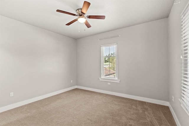 empty room with light colored carpet and ceiling fan