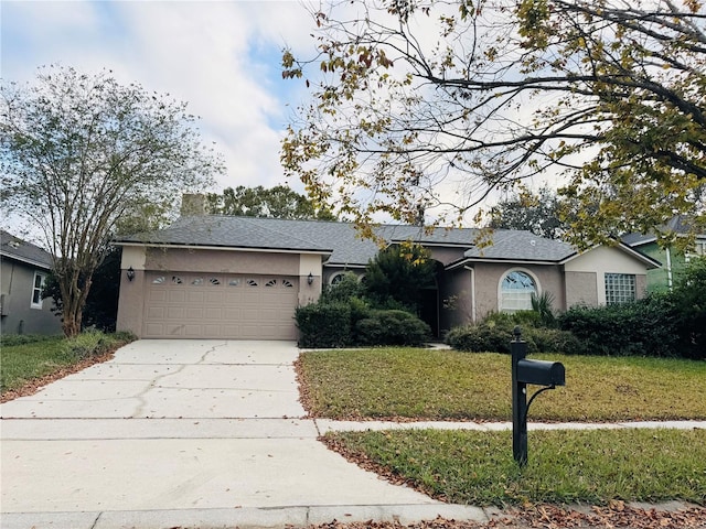 ranch-style home with a garage and a front lawn