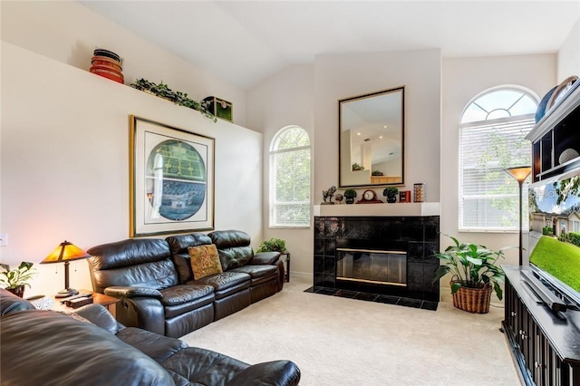 carpeted living room featuring vaulted ceiling and a fireplace