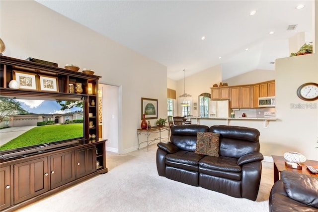 living room featuring light carpet and high vaulted ceiling