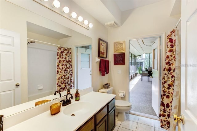 bathroom with tile patterned flooring, vanity, toilet, and walk in shower