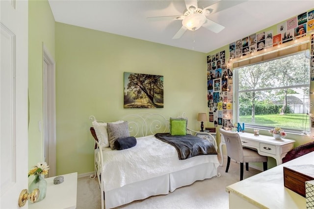 bedroom featuring light colored carpet and ceiling fan