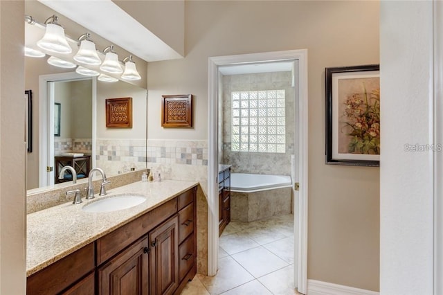 bathroom featuring vanity, a relaxing tiled tub, and tile patterned floors