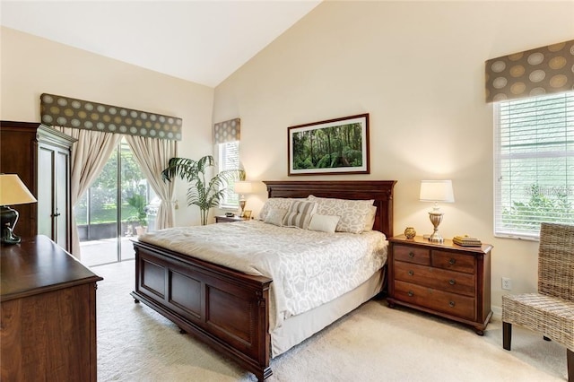 carpeted bedroom featuring access to outside and high vaulted ceiling