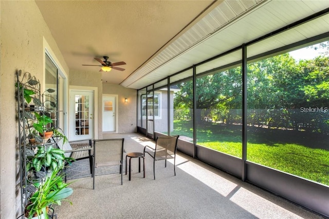 unfurnished sunroom featuring ceiling fan