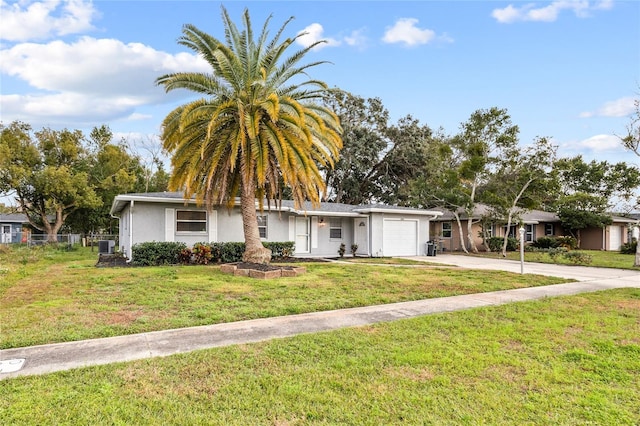 view of front of property with a garage and a front lawn