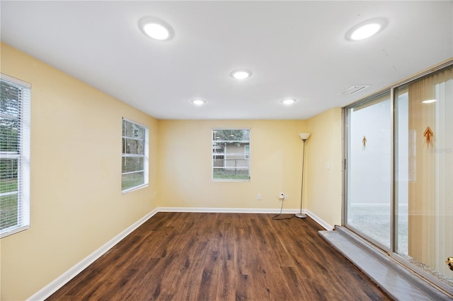 unfurnished room with baseboards, visible vents, and a healthy amount of sunlight