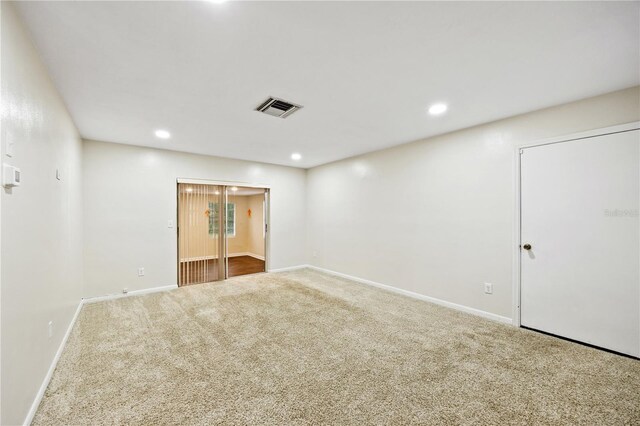 carpeted spare room featuring recessed lighting, visible vents, and baseboards