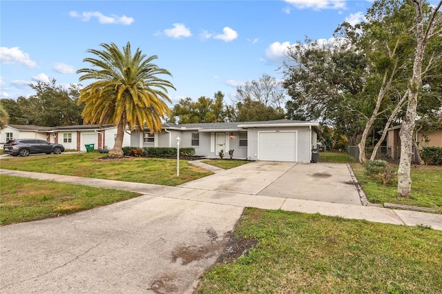 ranch-style home with stucco siding, an attached garage, fence, driveway, and a front lawn