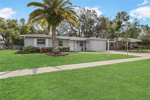 ranch-style home with stucco siding, an attached garage, driveway, and a front yard