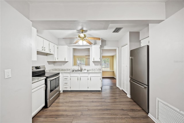 kitchen featuring dark wood-style floors, visible vents, appliances with stainless steel finishes, and a sink