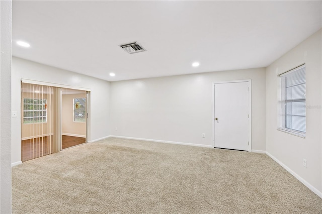 empty room featuring recessed lighting, visible vents, baseboards, and carpet flooring