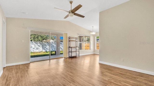 unfurnished living room with ceiling fan, vaulted ceiling, and wood-type flooring