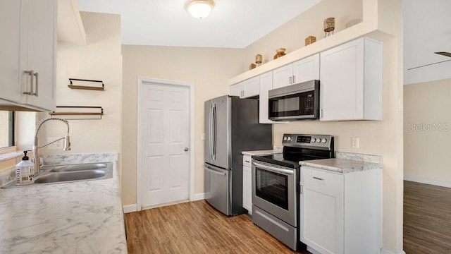 kitchen featuring white cabinets, light hardwood / wood-style flooring, stainless steel appliances, and sink
