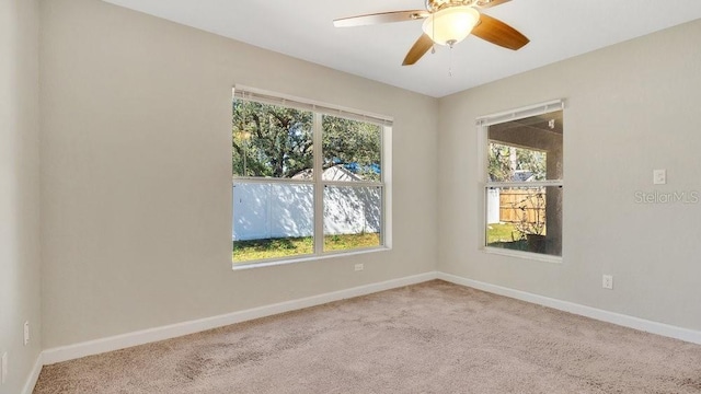 carpeted empty room featuring ceiling fan