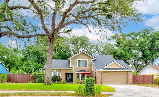 view of front of house with a garage and a front yard