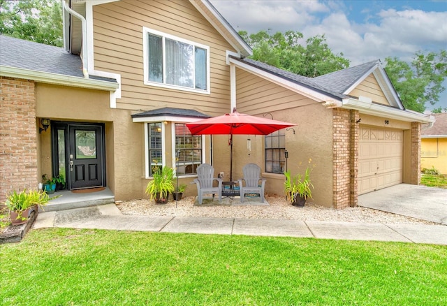 view of front of property featuring a shingled roof, concrete driveway, brick siding, and a garage