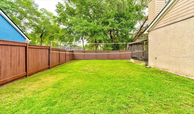 view of yard with a fenced backyard