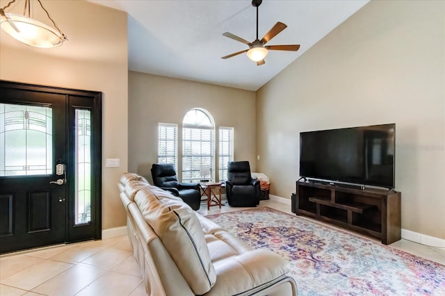interior space featuring lofted ceiling, light tile patterned floors, and baseboards