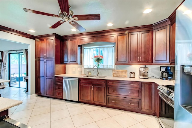 kitchen with ceiling fan, stainless steel appliances, a sink, and light countertops