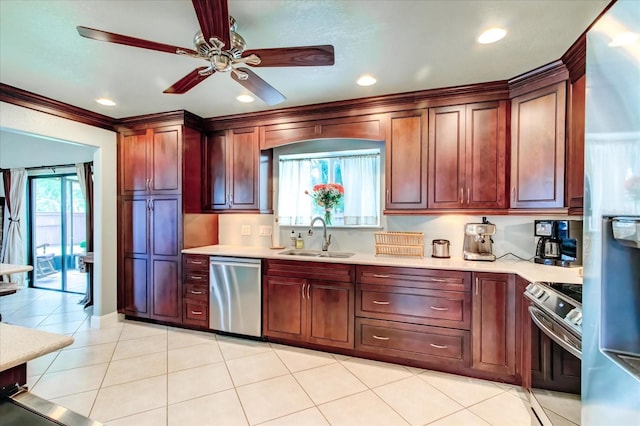 kitchen with stainless steel appliances, light countertops, a sink, and a ceiling fan