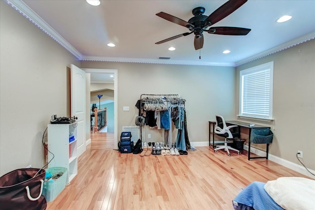 interior space featuring baseboards, wood finished floors, visible vents, and crown molding