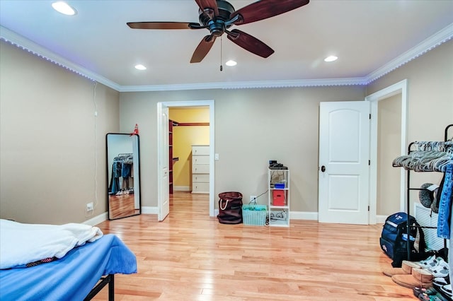 bedroom featuring ornamental molding, light wood-style flooring, and baseboards