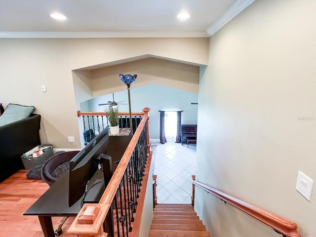 stairway with ornamental molding, wood finished floors, and recessed lighting