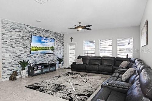 living room with concrete floors and ceiling fan