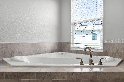 bathroom with tiled bath