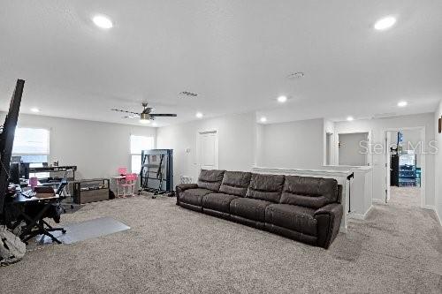 living room with plenty of natural light and light colored carpet