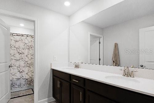 bathroom featuring vanity and a shower with curtain