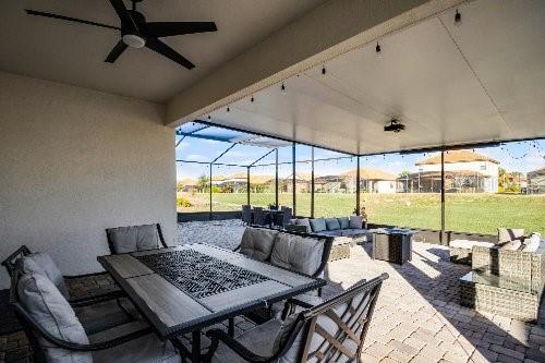 view of patio / terrace featuring a lanai, an outdoor hangout area, and ceiling fan