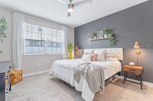 bedroom featuring light colored carpet and ceiling fan