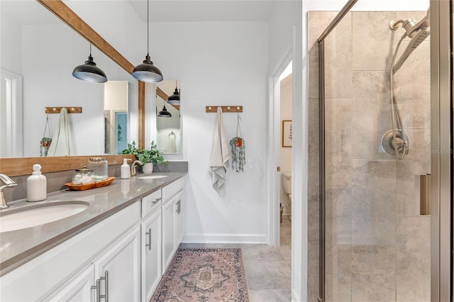 bathroom featuring vanity, toilet, and an enclosed shower