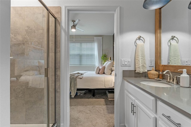 bathroom featuring ceiling fan, vanity, and a shower with shower door