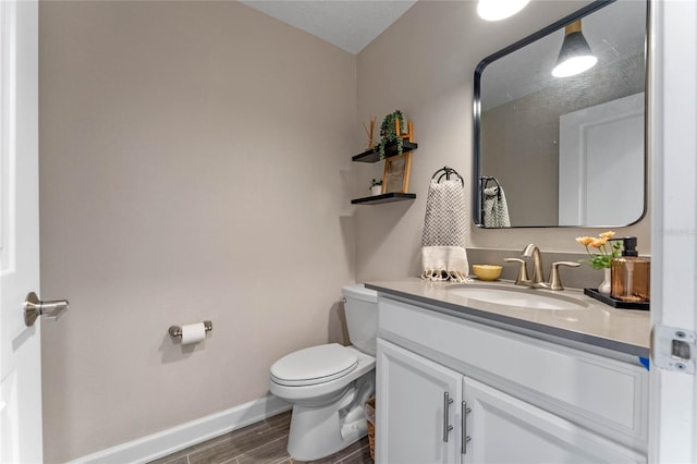 bathroom featuring vanity, toilet, and hardwood / wood-style floors