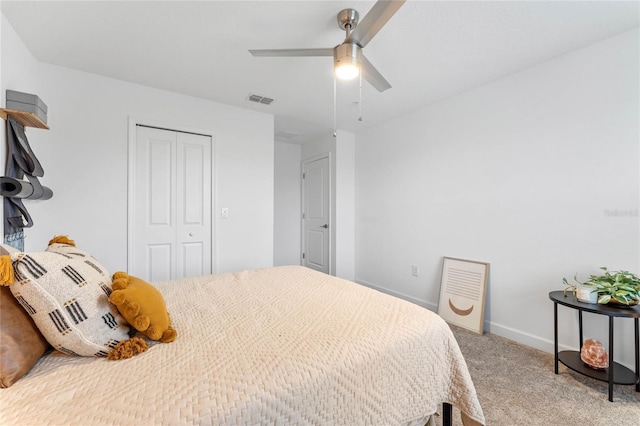 carpeted bedroom featuring ceiling fan and a closet