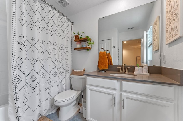 full bathroom with vanity, shower / tub combo with curtain, and toilet