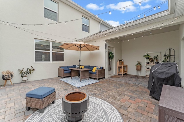 view of patio featuring a grill and an outdoor living space with a fire pit