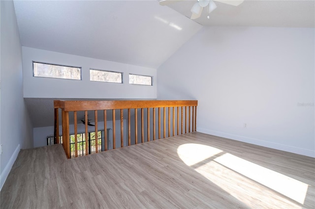 bonus room featuring hardwood / wood-style floors, vaulted ceiling, and ceiling fan