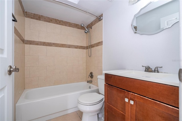 full bathroom featuring vanity, tile patterned flooring, tiled shower / bath combo, and toilet