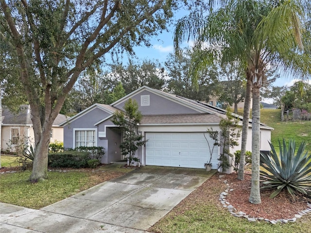 ranch-style home featuring a garage and a front lawn