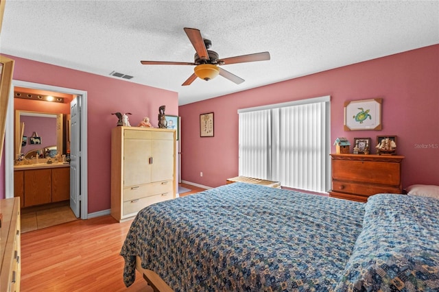 bedroom featuring ceiling fan, a textured ceiling, and light hardwood / wood-style flooring