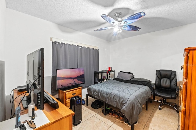 bedroom with light tile patterned flooring, ceiling fan, and a textured ceiling