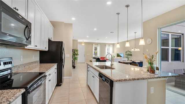 kitchen featuring white cabinets, a kitchen island with sink, sink, and black appliances