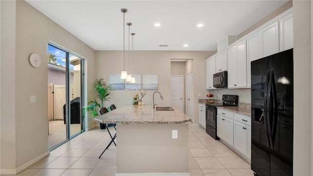 kitchen featuring white cabinetry, sink, hanging light fixtures, light stone counters, and black appliances