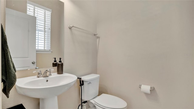 bathroom featuring sink and toilet