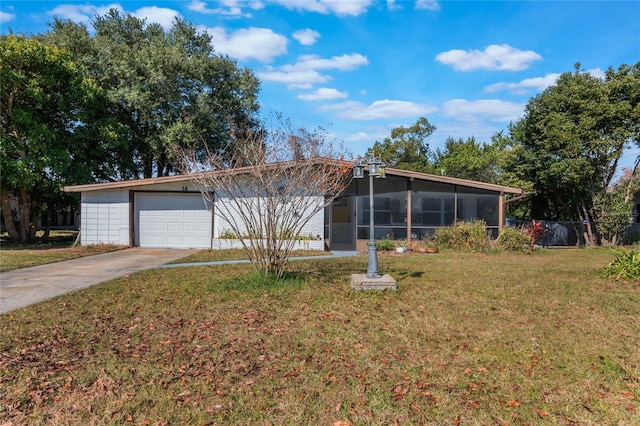 ranch-style home with a garage, a sunroom, and a front lawn